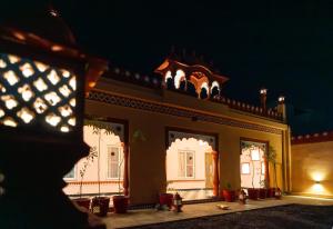 a building with lights on top of it at night at Fort Jangaldhar in Bikaner