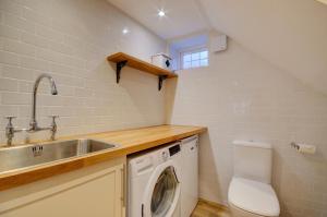 a small kitchen with a sink and a washing machine at 3 Bed in Fowey oc-p00647 in Fowey +14 photos