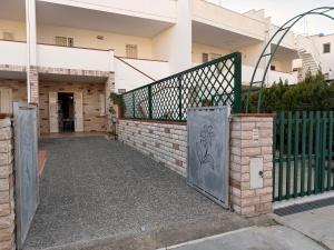 an entrance to a building with a metal gate at Baia Incantata in Baia Verde