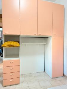 a kitchen with pink cabinets and a refrigerator at Baia Incantata in Baia Verde
