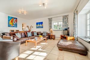 a living room with a couch and a table at 3 Bed in Polperro oc-h34100 in Polperro