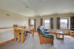 a living room with a dining room table and chairs at 1 Bed in Cowling oc-ds237 in Cowling +7 photos