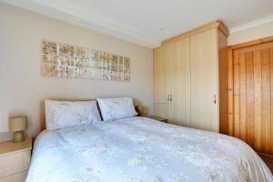 a bedroom with a bed and a wooden cabinet at 1 Bed in Cowling oc-ds237 in Cowling