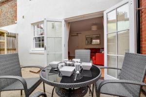 a patio with a black table and chairs at 4 Bed in Cromer oc-1942 in Cromer