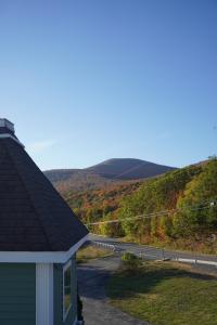 a house with a view of a road and mountains at The Perch Hotel in East Windham