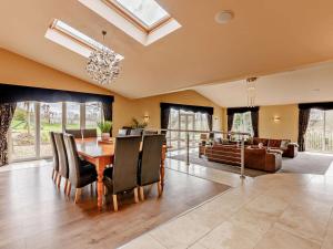 a dining room with a table and a couch at 6 Bed in Morpeth oc-91805 in Ellington