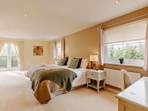 a bedroom with a large bed and a window at 6 Bed in Morpeth oc-91805 in Ellington