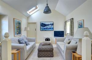 a living room with two couches and a fireplace at 2 Bed in Menai Bridge oc-fl046 in Llandegfan