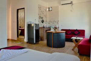 a living room with a refrigerator and a kitchen at Hotel City Inn - Mountain View in Pokhara