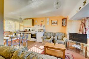 a living room with a couch a table and a kitchen at 2 Bed in Mundesley oc-673 in Mundesley