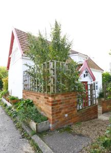 a house with a fence with trees in it at 2 Bed in Sweffling oc-whcs in Rendham