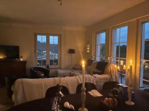 a living room with a table and candles in it at La Villa des Hauts Chênes in Bouillon
