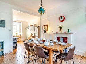 a dining room with a wooden table and chairs at 4 Bed in Woolacombe oc-90224 in Mortehoe
