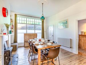 a dining room with a wooden table and chairs at 4 Bed in Woolacombe oc-90224 in Mortehoe +24 photos