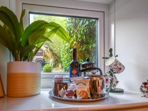 a tray of food and wine on a counter next to a window at 2 Bed in Penrith oc-sz276 in Stainton