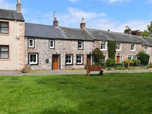 a stone house with a bench in front of it at 2 Bed in Penrith oc-sz276 in Stainton +6 photos
