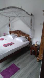 a bedroom with a large bed with a canopy at Lucky Palace in Beruwala