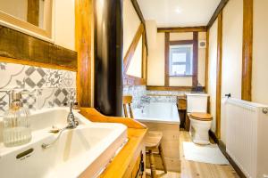 a bathroom with a tub and a toilet and a sink at 3 Bed in Gressenhall oc-o28417 in East Dereham
