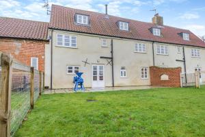 a large house with a yard in front of it at 3 Bed in Gressenhall oc-o28417 in East Dereham