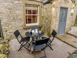 a patio with a table and chairs in front of a building at 2 Bed in Matlock oc-77632 in Brassington