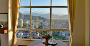 a large window with a view of a city at Hotel City Inn - Mountain View in Pokhara