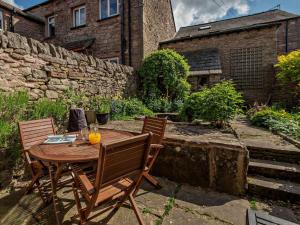 a wooden table and chairs in a garden at 2 Bed in Kirkby Stephen oc-sz144 in Kirkby Stephen