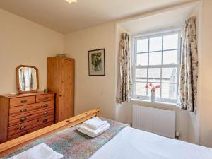 a bedroom with a bed and a window and a dresser at 2 Bed in Kirkby Stephen oc-sz144 in Kirkby Stephen +4 photos
