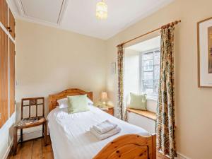 a bedroom with a bed and a window at 2 Bed in Kirkby Stephen oc-sz144 in Kirkby Stephen