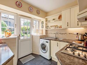a kitchen with a washing machine and a sink at 2 Bed in Kirkby Stephen oc-sz144 in Kirkby Stephen
