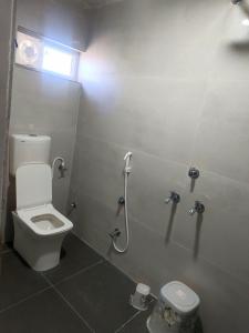 a bathroom with a toilet and a shower stall at Hotel Jayaswal INN in Bharbharia