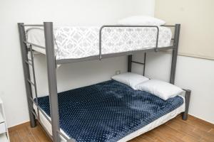 a bunk bed with two pillows on the bottom bunk at Depto. 2 rec. con acceso al Río in Boca del Río
