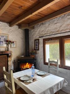a dining table with a white tablecloth and a fireplace at Hostal Avenjúcar in Tolosa