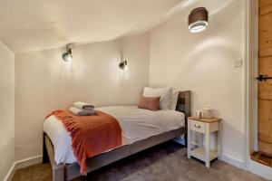 a small bedroom with a bed and a night stand at 2 Bed in Lavenham oc-s30055 in Lavenham