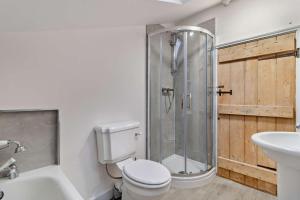 a bathroom with a shower and a toilet and a sink at 2 Bed in Lavenham oc-s30055 in Lavenham +10 photos