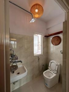 a bathroom with a toilet and a sink at Avalokiteśvara Āvāsa in Kathmandu