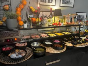 a buffet with many different types of food at DORMERO Hotel Xanten in Xanten