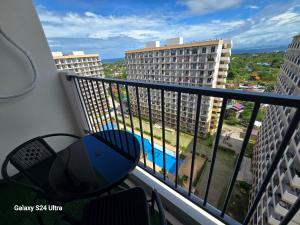 a balcony with a view of a pool and buildings at staycaSHAWN studio in Lapu Lapu City