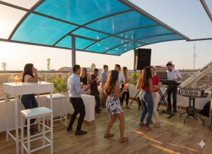 a group of people standing on a rooftop playing music at Hotel Venture in Chincha Alta +64 photos