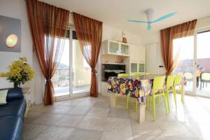 a kitchen with a table and chairs in a room at WI-RO Carminati - Mare e relax in Marina di Andora +13 photos