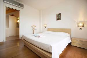 a bedroom with a large white bed in a room at WI-RO Carminati - Mare e relax in Marina di Andora