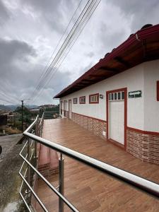 a building with a wooden deck on the side of it at Apartamento Rústico Moderno in Ruiosucio
