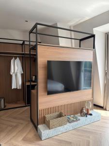 a living room with a large television in a room at Ama Retreat in Buôn Enao