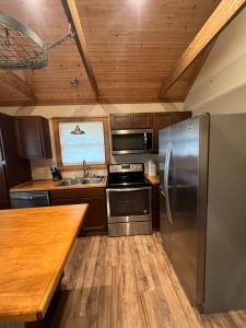 a kitchen with a stainless steel refrigerator and a wooden counter at Cottage No 4 on Ranch in McKinney