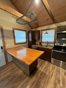 a kitchen with a wooden counter top and a sink at Cottage No 4 on Ranch in McKinney +6 photos