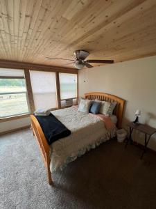 a bedroom with a bed with a wooden ceiling at Cottage No 4 on Ranch in McKinney