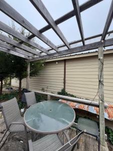 a patio with a table and chairs under a pergola at Cottage No 4 on Ranch in McKinney