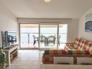a living room with a couch and a view of the ocean at Apartamento Mardevela in Sanxenxo