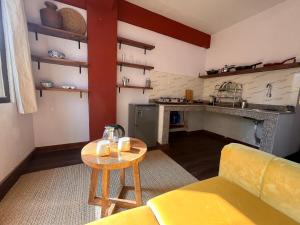 a living room with a yellow couch and a table at Mandāravā Āvāsa in Kathmandu