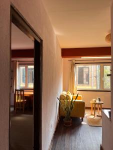 a living room with a yellow couch and a table at Mandāravā Āvāsa in Kathmandu +12 photos