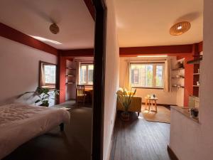 a bedroom with red walls and a bed and a table at Mandāravā Āvāsa in Kathmandu